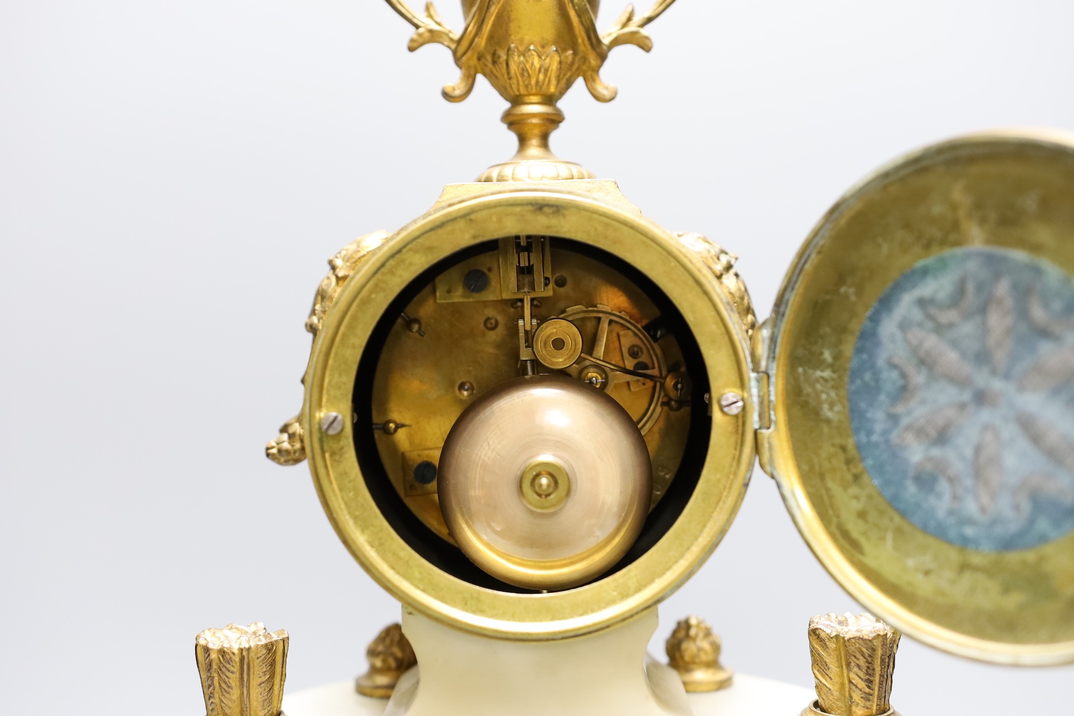 A four pillar French white marble and gilt metal clock garniture, 43 cms high